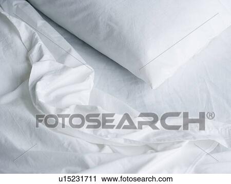 Stock Image - Still life of pillow and bed sheets. Fotosearch