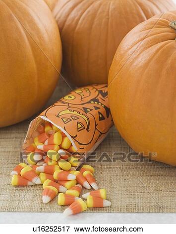 Stock Photo - Still life of pumpkins and candy corn. Fotosearch