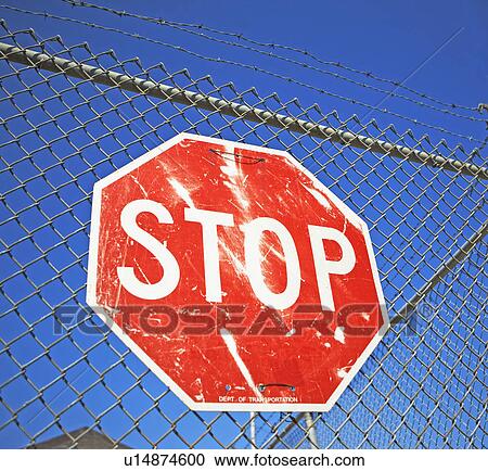 Stock Image - Stop sign on fence. Fotosearch