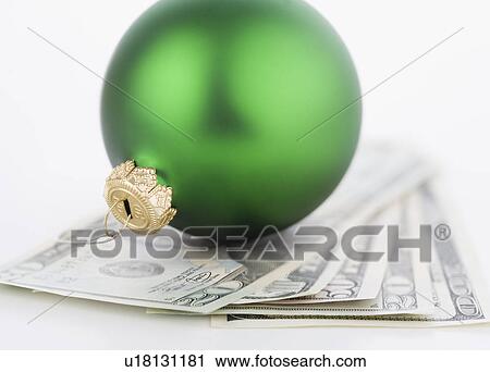 Studio shot of money and Christmas tree ornament View Large Photo Image Stock Image - Studio shot of money and Christmas tree ornament. Fotosearch