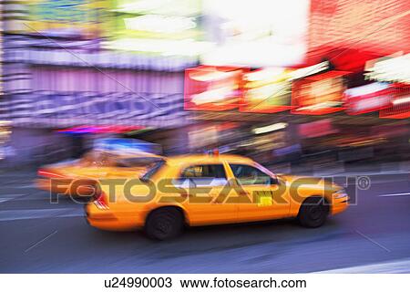 Stock Image - Taxi cab in Times Square, New York City. Fotosearch