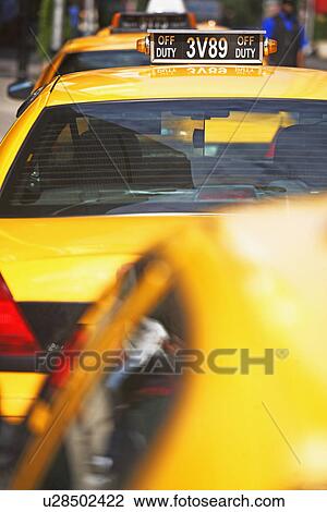Taxi cabs parked in line View Large Photo Image Stock Image - Taxi cabs parked in line. Fotosearch