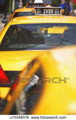 Taxi cabs parked in line View Large Photo Image Stock Photograph - Taxi cabs parked in line. Fotosearch