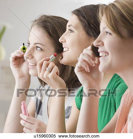 Teenage girls applying makeup View Large Photo Image Stock Photography - Teenage girls applying makeup. Fotosearch
