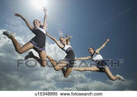 Three cheerleaders jumping View Large Photo Image Stock Photography - Three cheerleaders jumping. Fotosearch