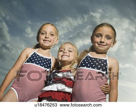 Three young sisters hugging View Large Photo Image Stock Image - Three young sisters hugging. Fotosearch