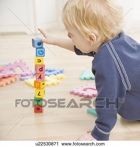 Stock Image - Toddler stacking blocks. Fotosearch