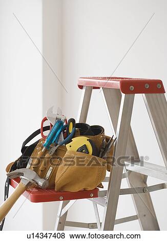 Tool belt on ladder shelf View Large Photo Image Stock Photo - Tool belt on ladder shelf. Fotosearch