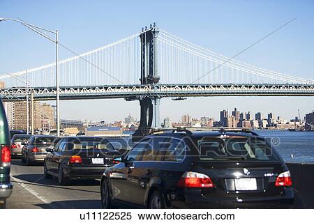 Traffic with bridge in background View Large Photo Image Stock Photography - Traffic with bridge in background. Fotosearch