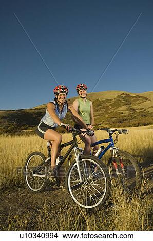 Picture - Two women on mountain bikes, Salt Flats, Utah, United States. Fotosearch