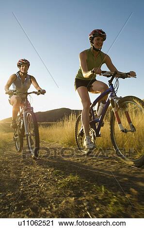 Two women riding mountain bikes, Salt Flats, Utah, United States View Large Photo Image Stock Image - Two women riding mountain bikes, Salt Flats, Utah, United States. Fotosearch