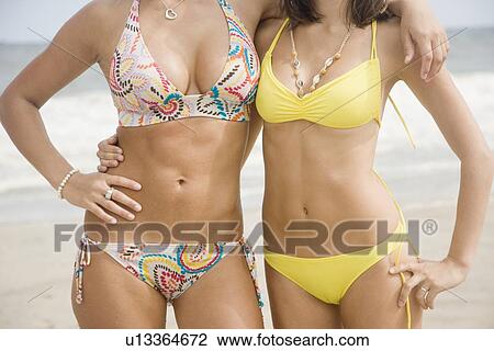 Stock Image - Two women wearing bikinis. Fotosearch