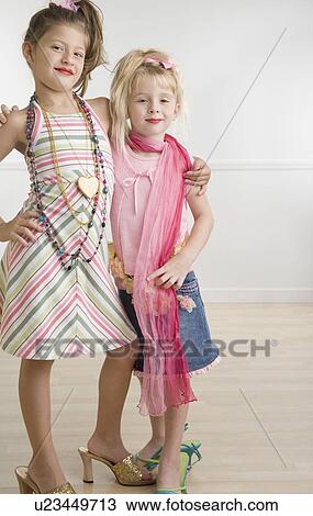 Two young sisters playing dress-up View Large Photo Image Stock Image - Two young sisters playing dress-up . Fotosearch