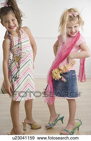 Stock Photo - Two young sisters playing dress-up . Fotosearch