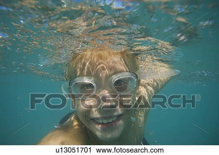 Stock Image - Underwater shot of boy swimming, Utah, United States. Fotosearch