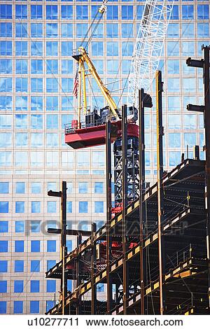 Stock Image - Urban construction site with crane. Fotosearch