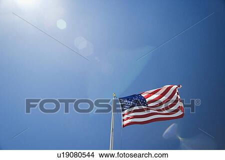 US flag against blue sky View Large Photo Image Picture - US flag against blue sky. Fotosearch
