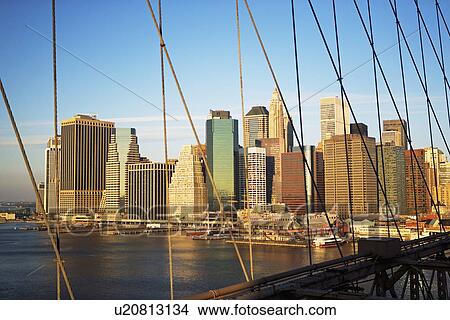 Picture - View of skyline through Brooklyn Bridge, New York City. Fotosearch