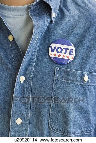 Vote pin on man’s shirt View Large Photo Image Picture - Vote pin on man’s shirt. Fotosearch