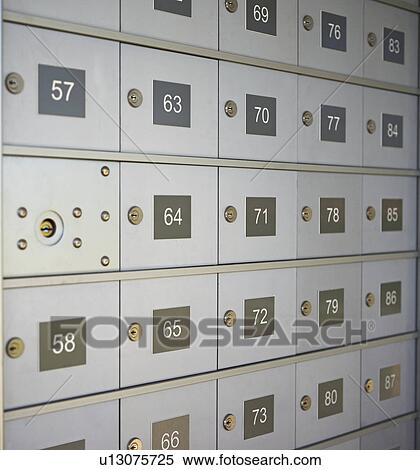 Stock Photography - Wall of numbered mailboxes. Fotosearch
