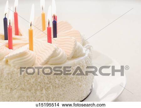 White cake with lit candles View Large Photo Image Picture - White cake with lit candles. Fotosearch