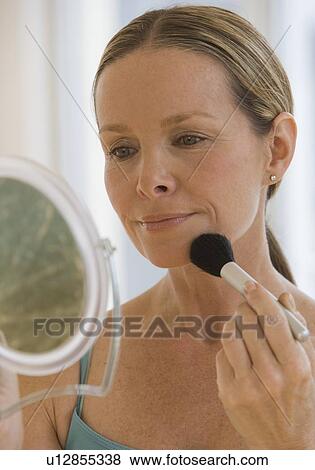 Woman applying makeup View Large Photo Image Stock Photo - Woman applying makeup. Fotosearch