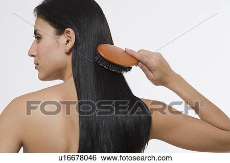 Stock Photograph - Woman brushing hair. Fotosearch