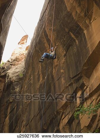 Woman canyon rappelling View Large Photo Image Stock Photograph - Woman canyon rappelling. Fotosearch