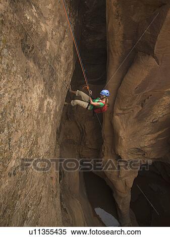 Woman canyon rappelling View Large Photo Image Stock Photography - Woman canyon rappelling. Fotosearch