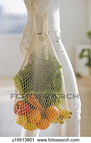 Woman carrying sack of fruit and vegetables View Large Photo Image Stock Image - Woman carrying sack of fruit and vegetables. Fotosearch