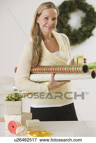 Woman carrying wrapping paper View Large Photo Image Stock Photo - Woman carrying wrapping paper. Fotosearch