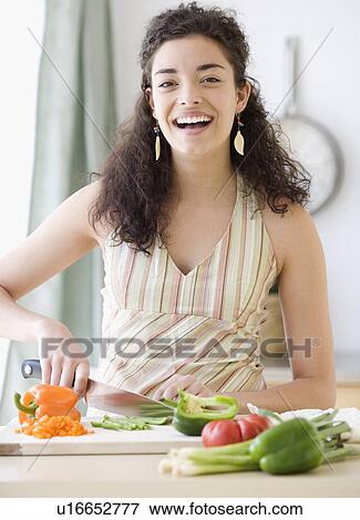 Woman chopping vegetables View Large Photo Image Stock Photo - Woman chopping vegetables. Fotosearch
