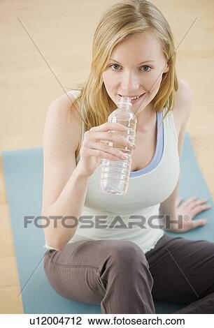 Stock Image - Woman drinking from water bottle. Fotosearch
