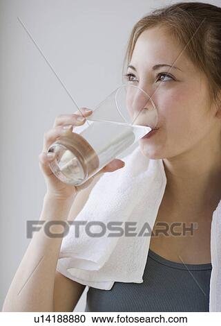 Woman drinking glass of water View Large Photo Image Stock Image - Woman drinking glass of water. Fotosearch