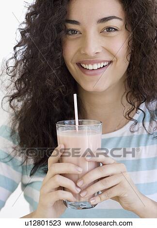 Stock Image - Woman drinking milkshake. Fotosearch