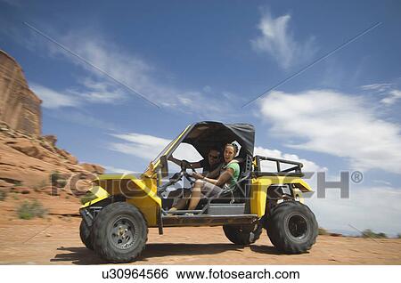 Woman driving off-road vehicle in desert View Large Photo Image Stock Photograph - Woman driving off-road vehicle in desert. Fotosearch