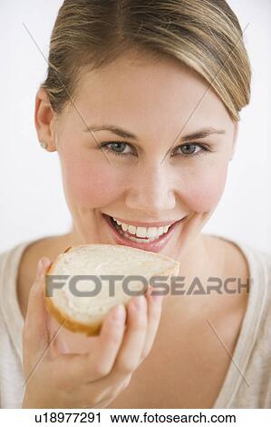 Stock Image - Woman eating bread and butter. Fotosearch