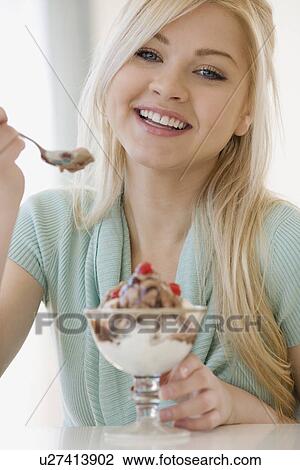 Woman eating ice cream sundae View Large Photo Image Stock Image - Woman eating ice cream sundae. Fotosearch