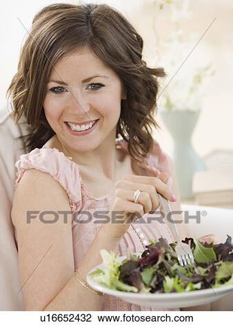 Stock Image - Woman eating salad. Fotosearch