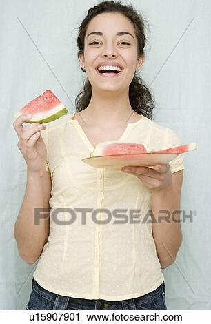 Woman eating watermelon slices View Large Photo Image Stock Image - Woman eating watermelon slices. Fotosearch