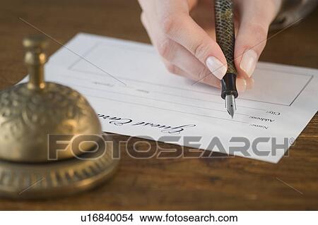 Woman filling out hotel registration View Large Photo Image Picture - Woman filling out hotel registration. Fotosearch