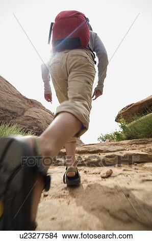 Picture - Woman hiking in desert. Fotosearch
