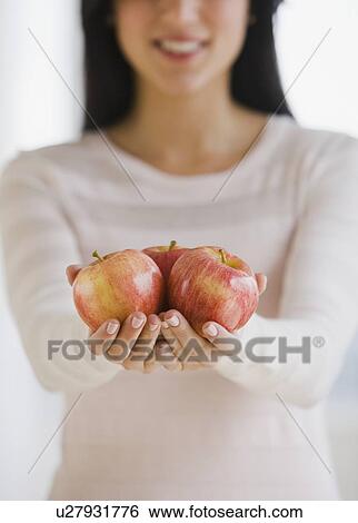 Stock Photograph - Woman holding apples. Fotosearch