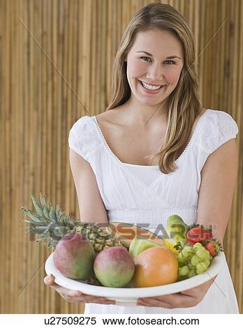 Woman holding bowl of fruit View Large Photo Image Stock Photography - Woman holding bowl of fruit. Fotosearch