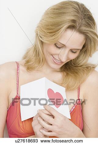 Stock Image - Woman holding card with heart. Fotosearch