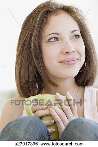 Stock Photograph - Woman holding coffee mug. Fotosearch