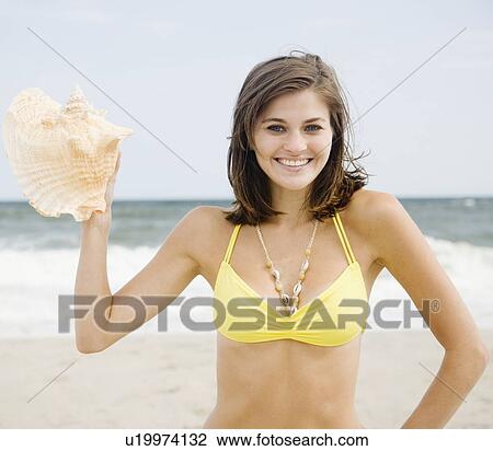 Woman holding conch shell View Large Photo Image Stock Image - Woman holding conch shell. Fotosearch