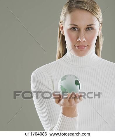 Stock Photograph - Woman holding glass globe. Fotosearch