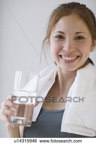 Stock Photograph - Woman holding glass of water. Fotosearch