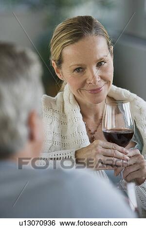 Stock Photograph - Woman holding glass of wine. Fotosearch